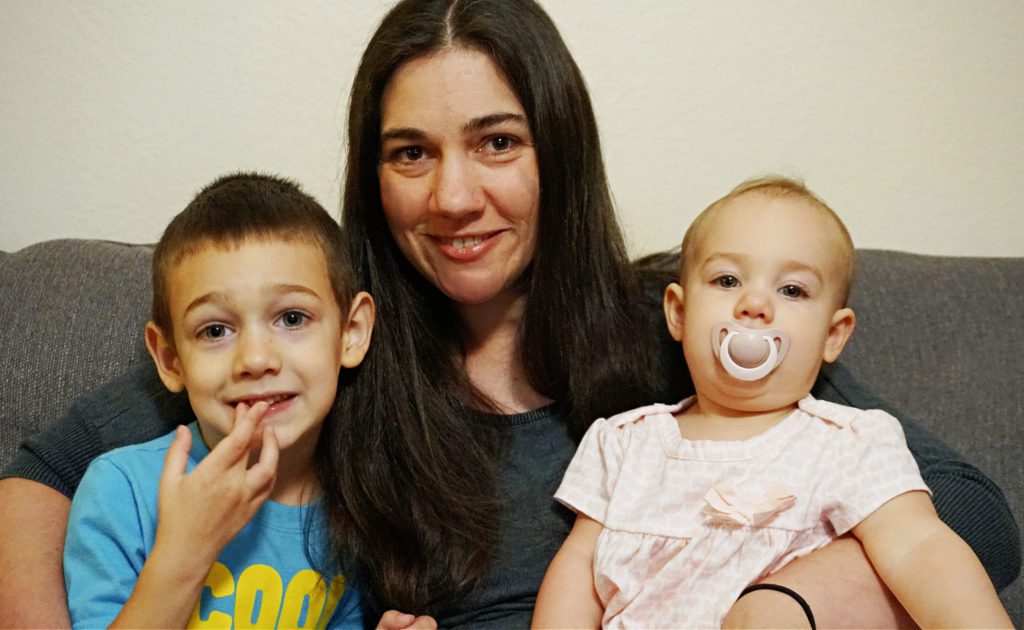 Sarah with her 2 kids sitting on the couch